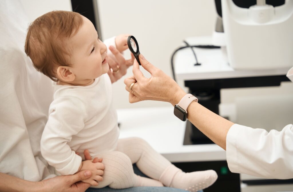 A baby being held during a pediatric eye exam