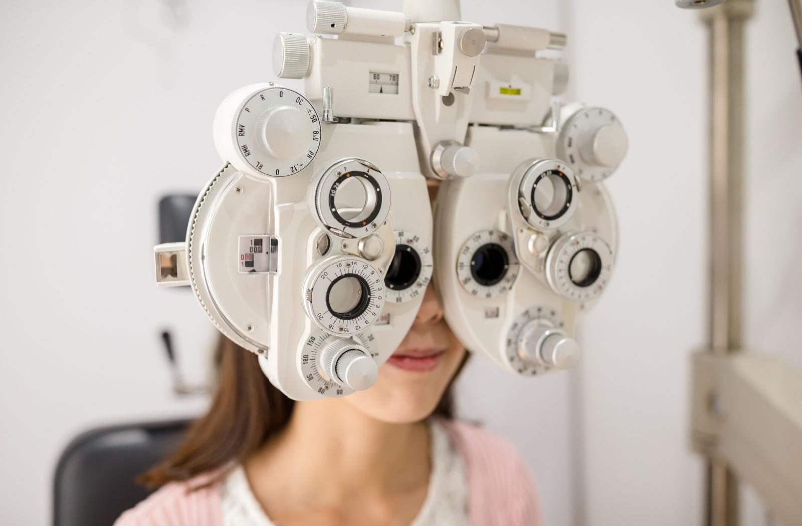 A person getting their glasses prescription updated during a routine eye exam